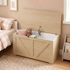 Wooden storage chest with open lid holding a teddy bear and books