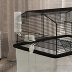 Black two-tier hamster cage with attached water bottle and sloped ramp