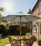 Grey market parasol with vented canopy and wooden pole over patio table