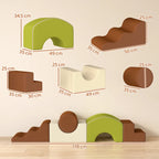 Five-piece foam climbing blocks in brown, cream, and green with varied shapes