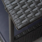 Close-up corner of grey woven rattan panels on an elevated dog bed