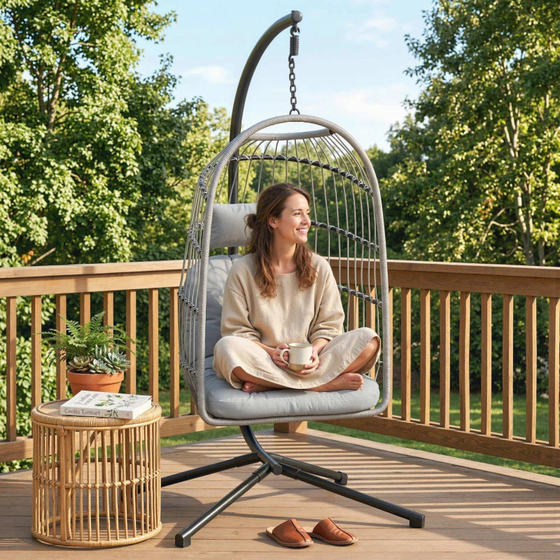 Light grey hanging egg chair with metal stand and padded seat cushion