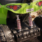 Green kids electric quad bike close-up of rear suspension springs and shock absorber