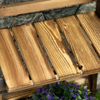 Close-up of brown wooden slat shelves on a 3-tier planter stand