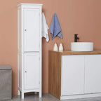 White tall cabinet with double doors and silver knobs beside sink cabinet