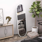White arched full-length mirror with rounded frame and legs, standing in a living room