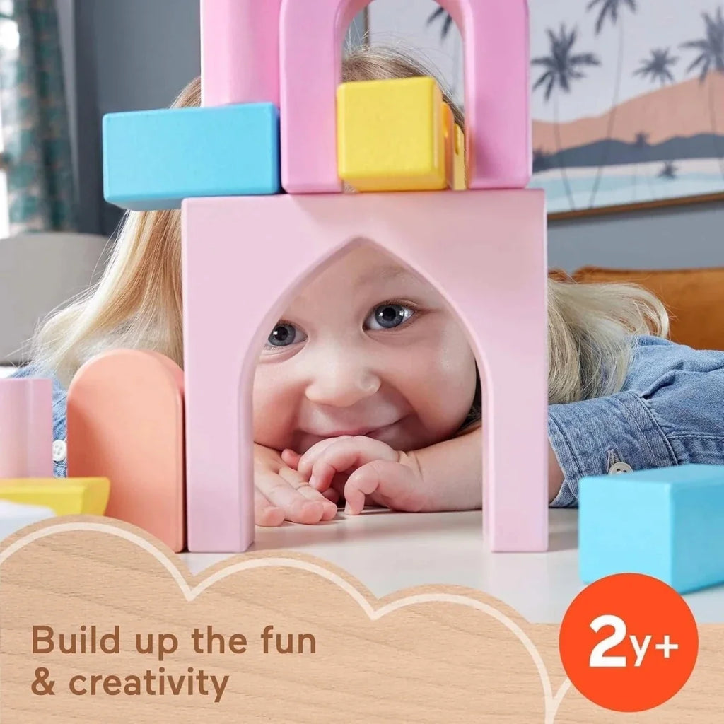 Pastel wooden castle block playset as a child smiles behind the arch frame