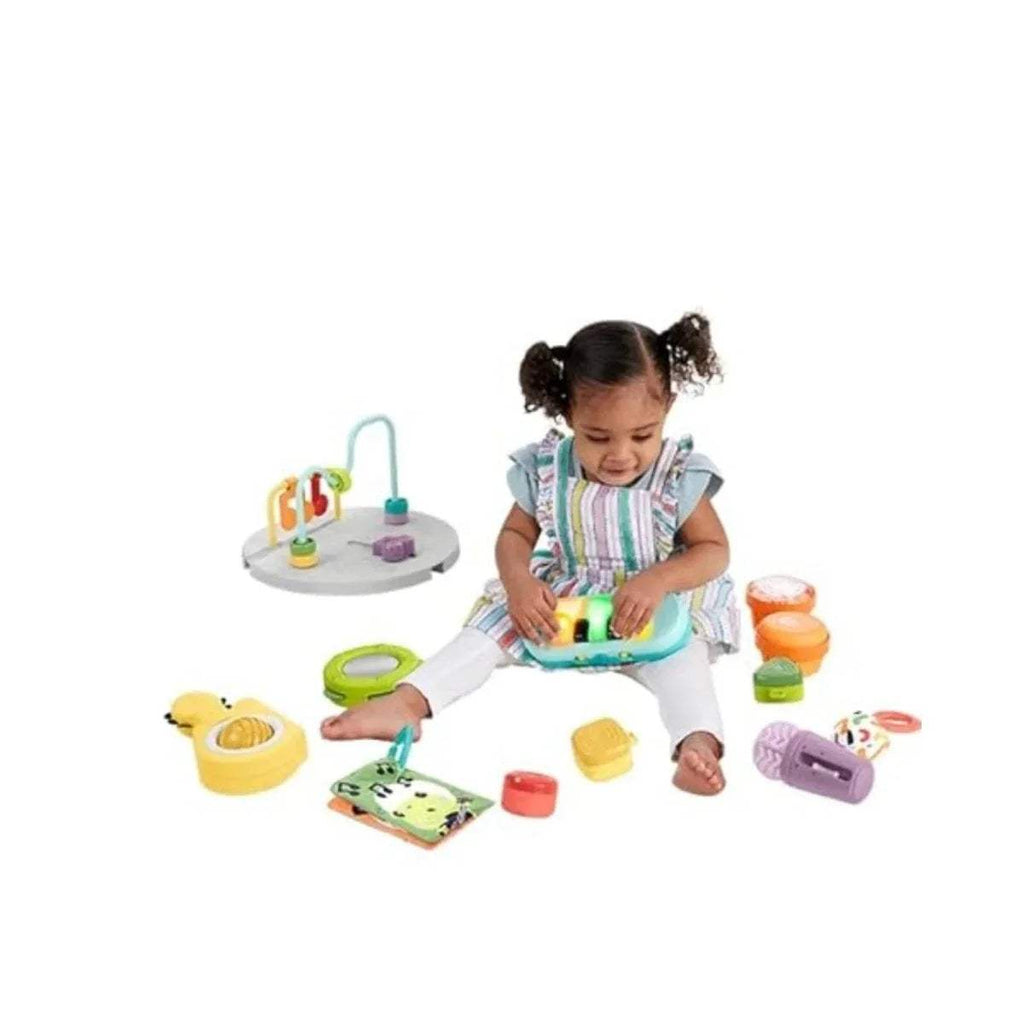 Baby activity centre with removable toys: green handle, purple toy, and molded blocks
