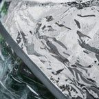 Black rain cover fabric with visible water droplets for a pet stroller canopy.