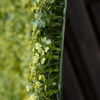 Artificial faux hedge panel edge view with dense bright green leaves