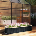 Dark grey raised garden bed with blooming flowers on an outdoor wooden deck