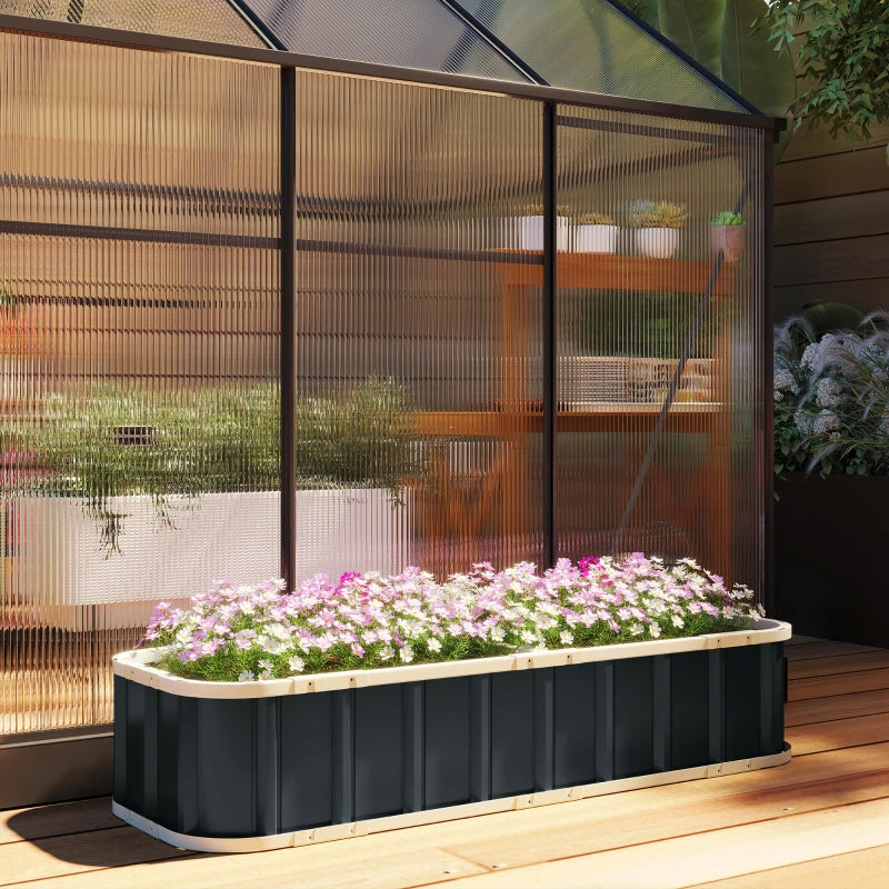 Dark grey raised garden bed with blooming flowers on an outdoor wooden deck