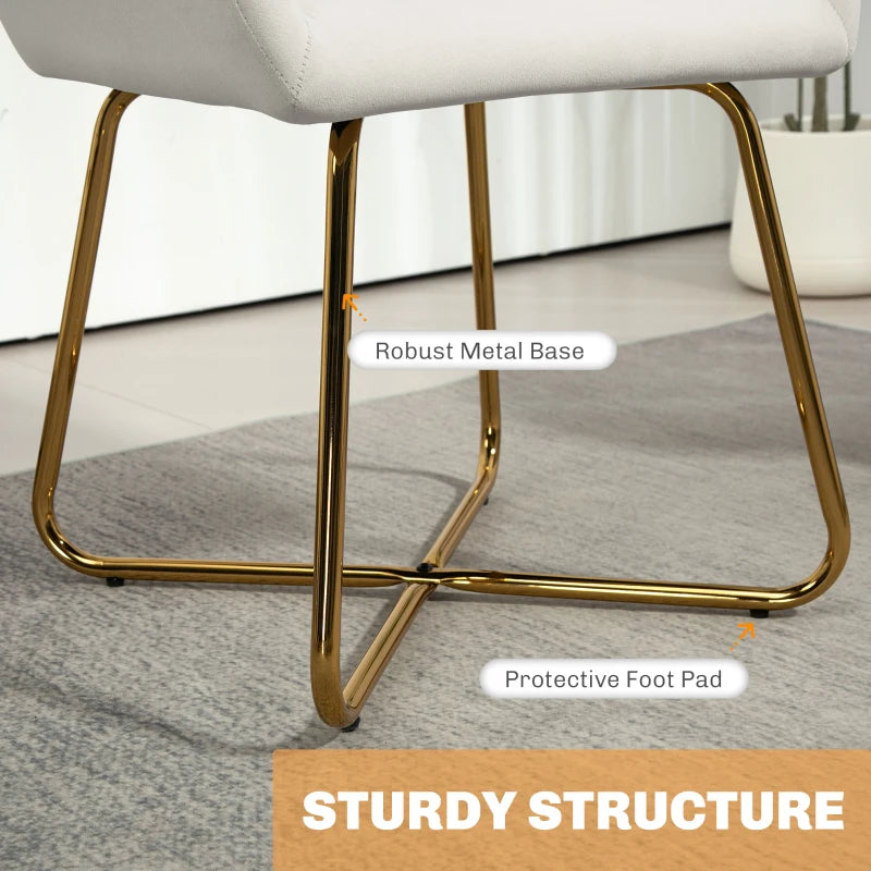 Cream upholstered accent chair with gold metal sled base and protective foot pads