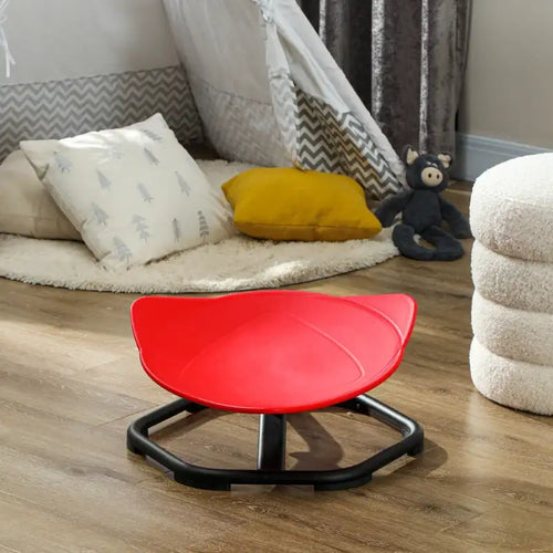 Red kids spinning chair with black base standing on an indoor floor
