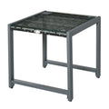 Grey outdoor end table with glass top and woven rattan surface