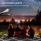 Outdoor rug with black-and-white zigzag diamond pattern, lit LED string lights
