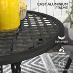 Black slatted grid tabletop with central parasol hole on curved base legs