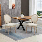 Set of two cream dining chairs with oval backrests, upholstered cushions, and wooden legs