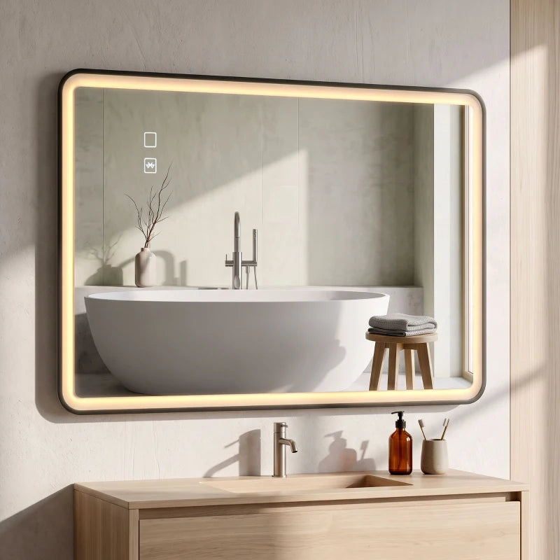 Black-framed rectangle LED bathroom mirror above a white sink with lit perimeter