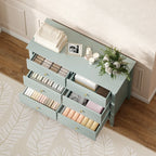 Green fluted dresser with multiple open drawers for organized storage