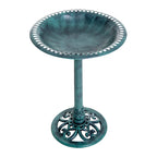 Green cast-metal bird bath with scalloped rim and ornate swirled pedestal base