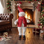 Standing skiing Santa figure wearing red scarf and hat, holding ski poles near fireplace