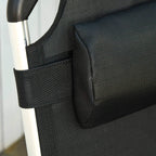 Close-up of black textured mesh seat and padded armrest ends on silver metal frame