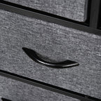 Close-up of dark grey fabric drawer front with curved black pull handle