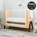 Convertible baby cot bed, natural wood frame with white slatted sides and dark legs
