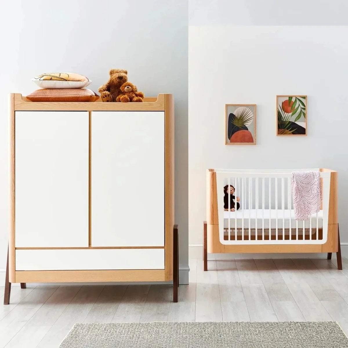 Convertible baby cot bed with white slats and natural wood frame, with matching cabinet