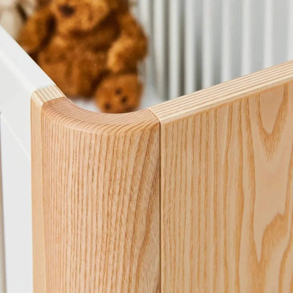 Natural wood cot bed corner post with rounded edge and visible grain