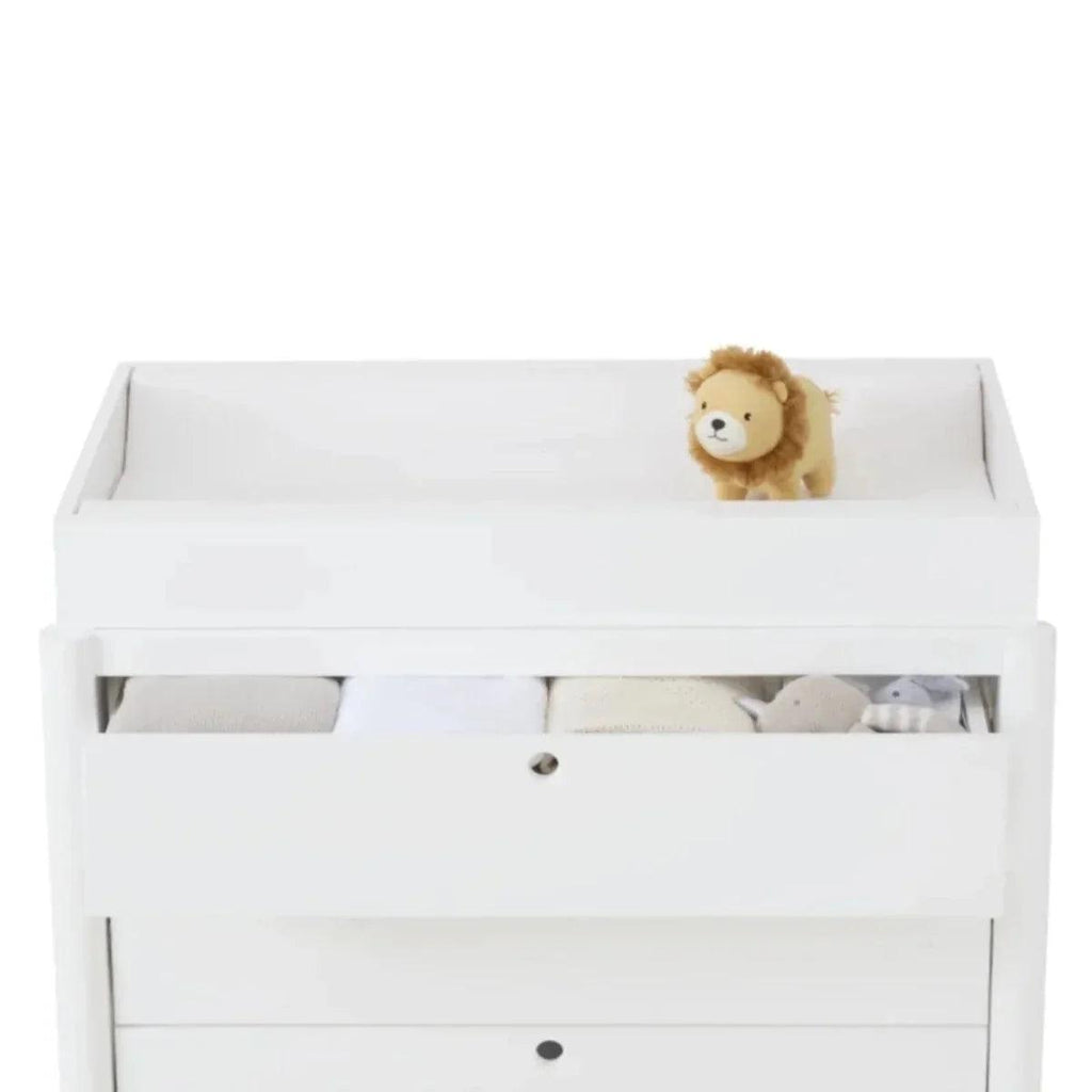 White toddler bed frame with open front drawer and a plush lion on the top rail