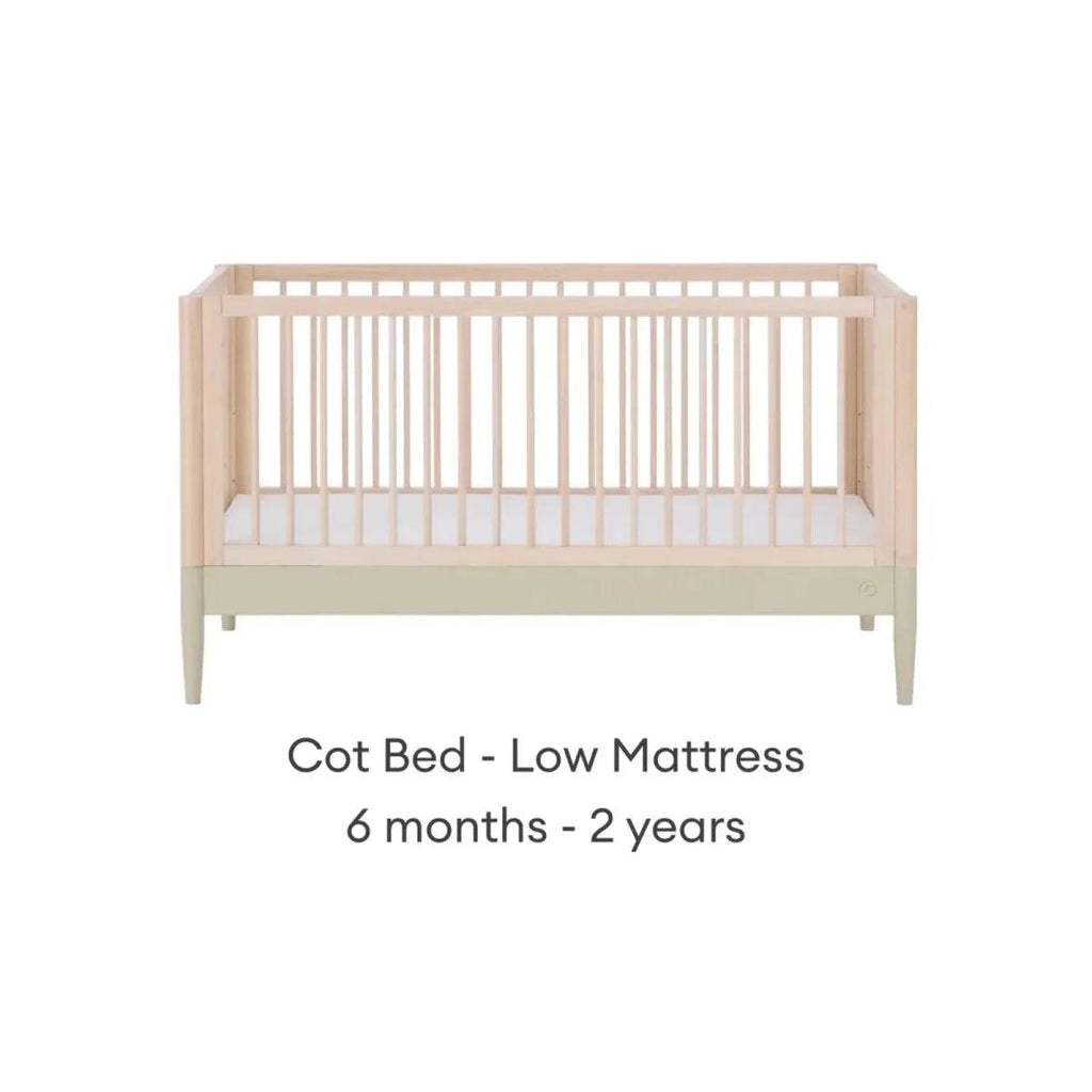 Light wood cot bed with vertical slats and sage rail, low mattress position