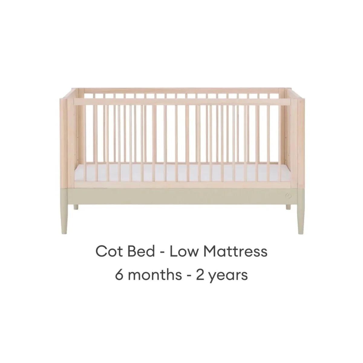 Light wood cot bed with vertical slats and sage rail, low mattress position
