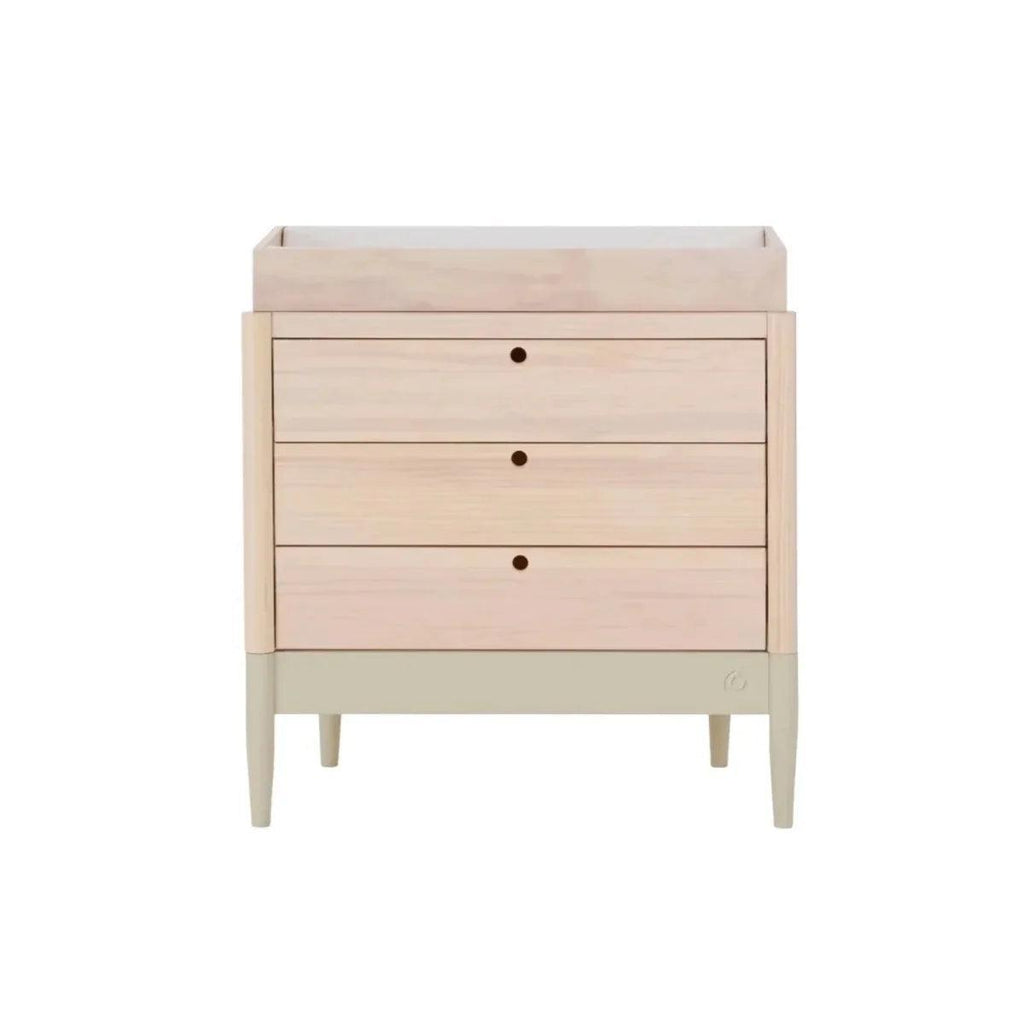 Wood baby changing dresser with three drawers and small round knobs; pale sage base