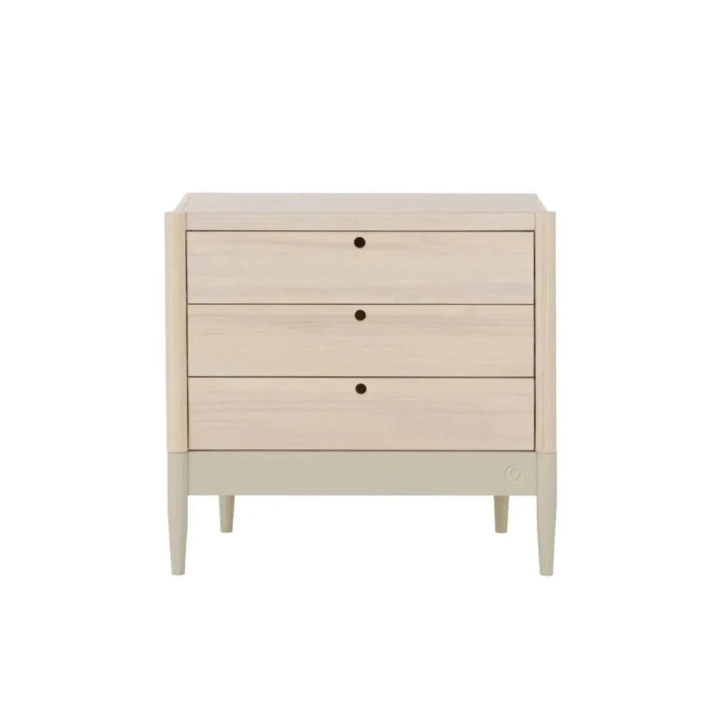 Wood baby changing dresser with three drawers and round dot knobs; pale sage panel