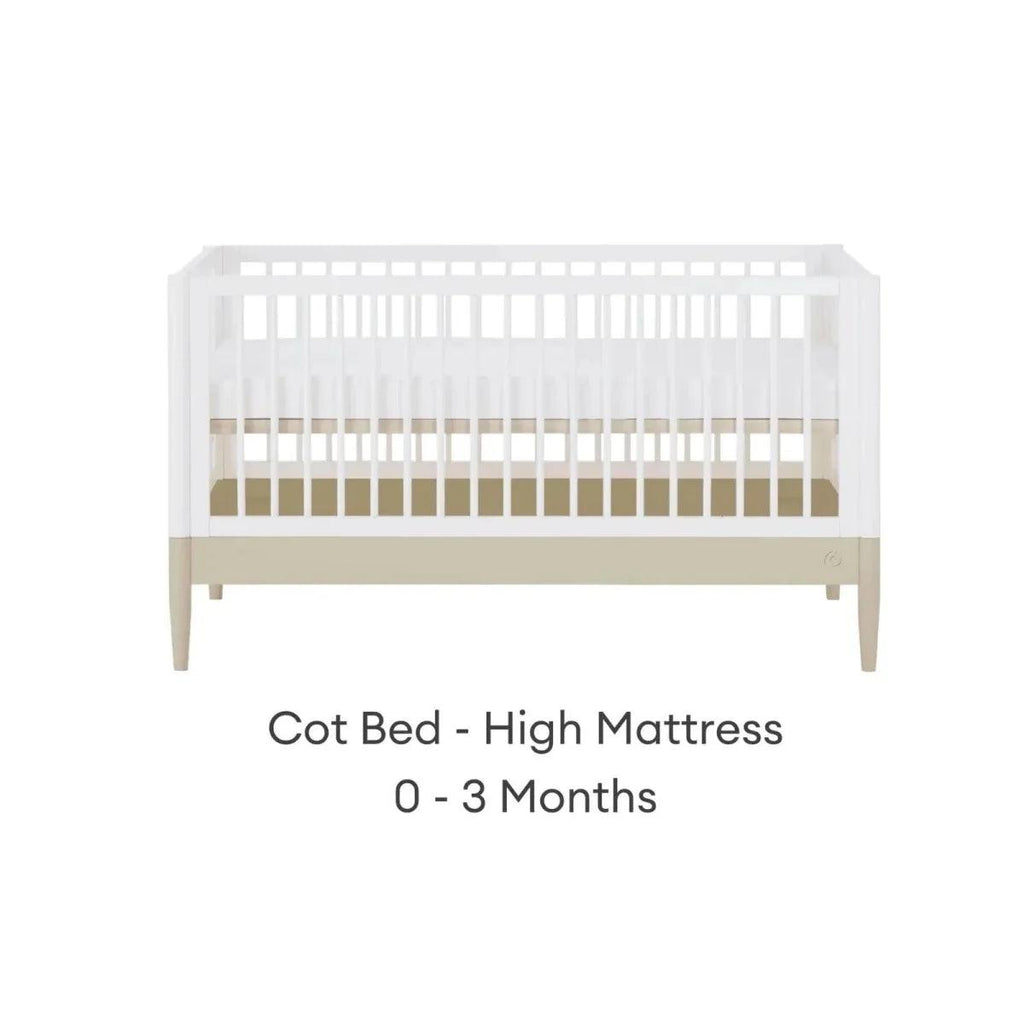 White cot bed frame with high mattress position and light wood legs