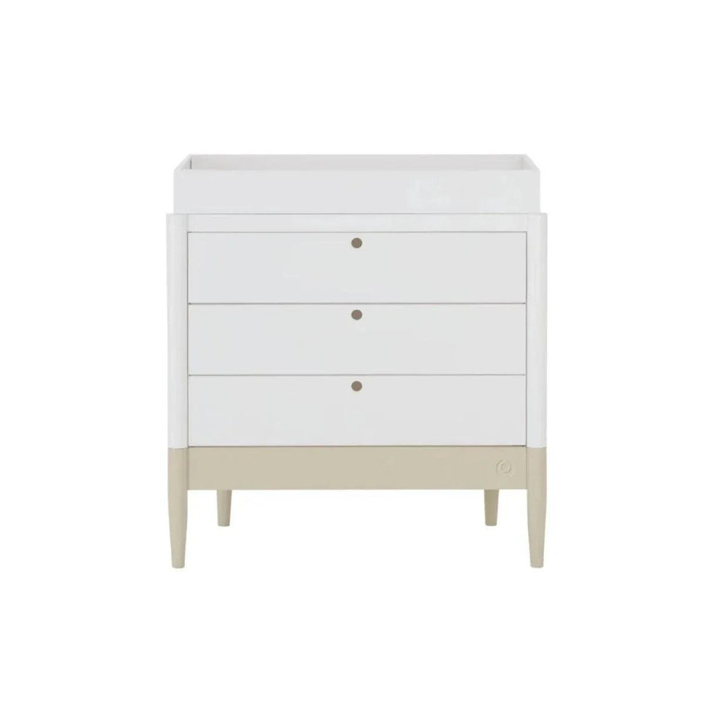 White baby dresser with three drawers, round knobs, and desert sage base strip