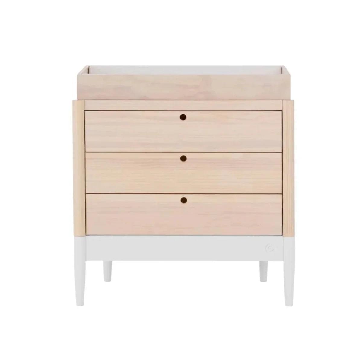 Wooden baby changing unit with three drawers and round pull knobs, natural ash