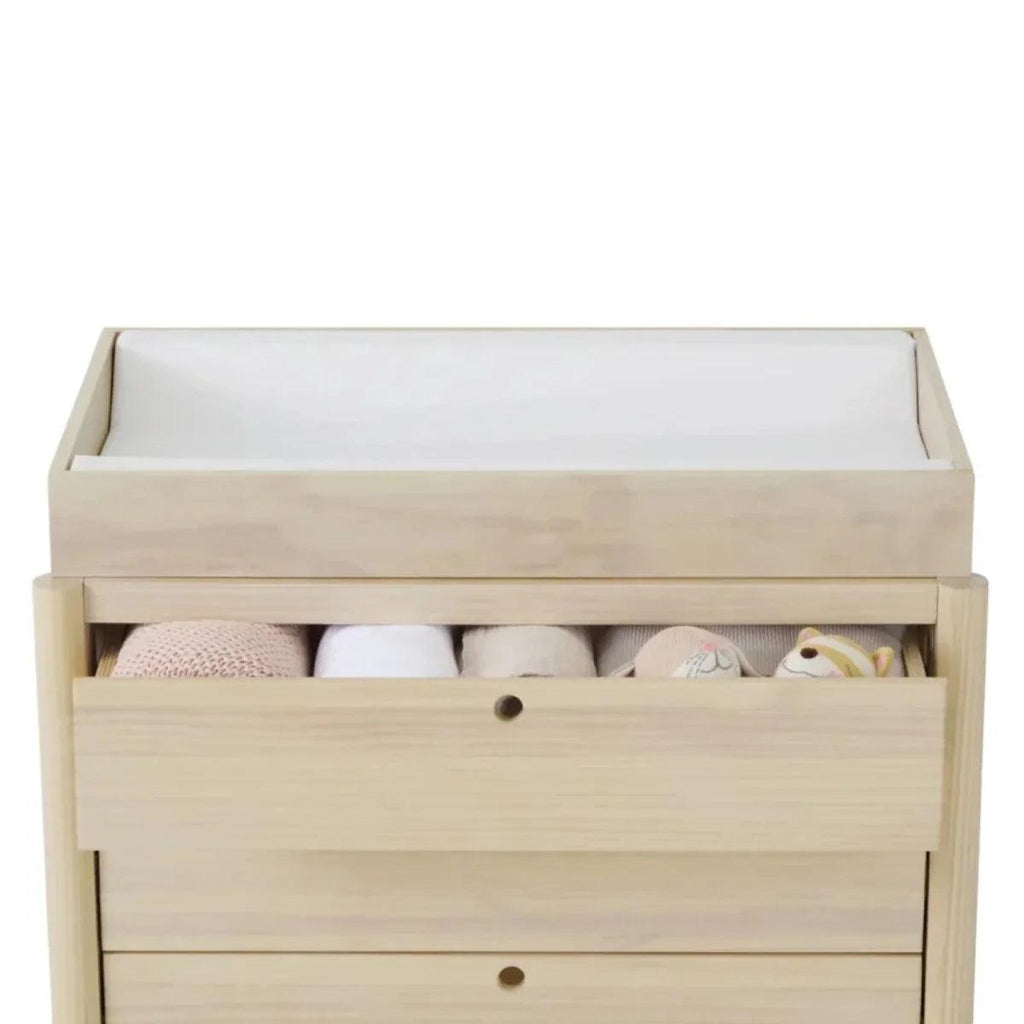 Wooden baby crib with open drawer storage and visible bedding, natural ash