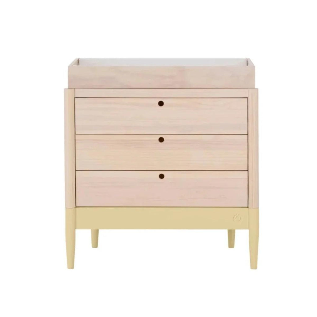 Wood baby dresser with three drawers, round knob pulls, and pale yellow base
