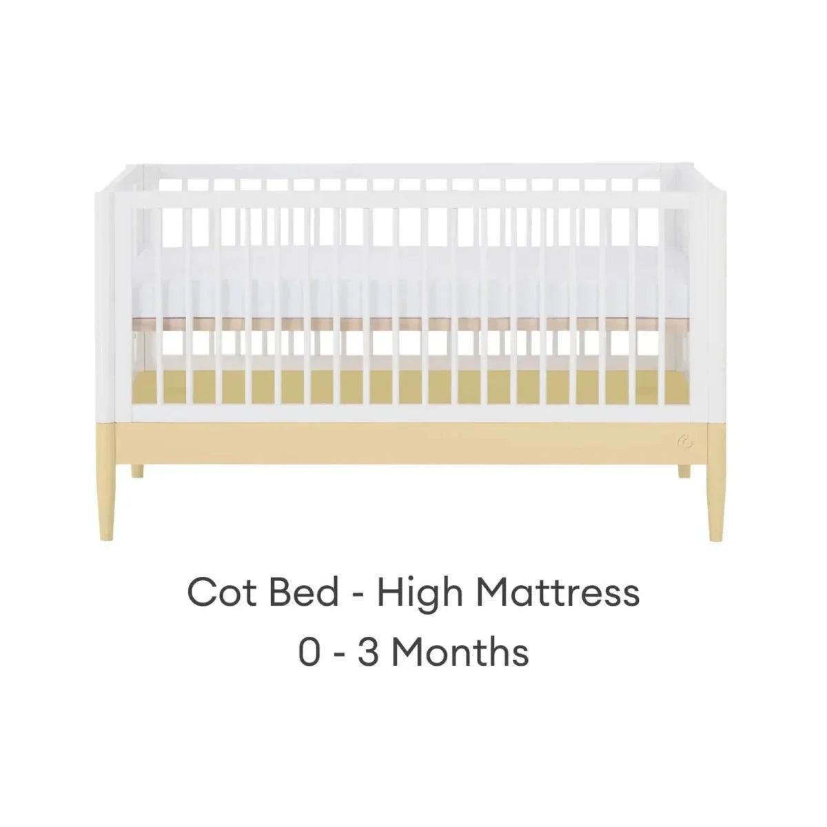 White cot bed with primrose yellow base rail and high mattress position