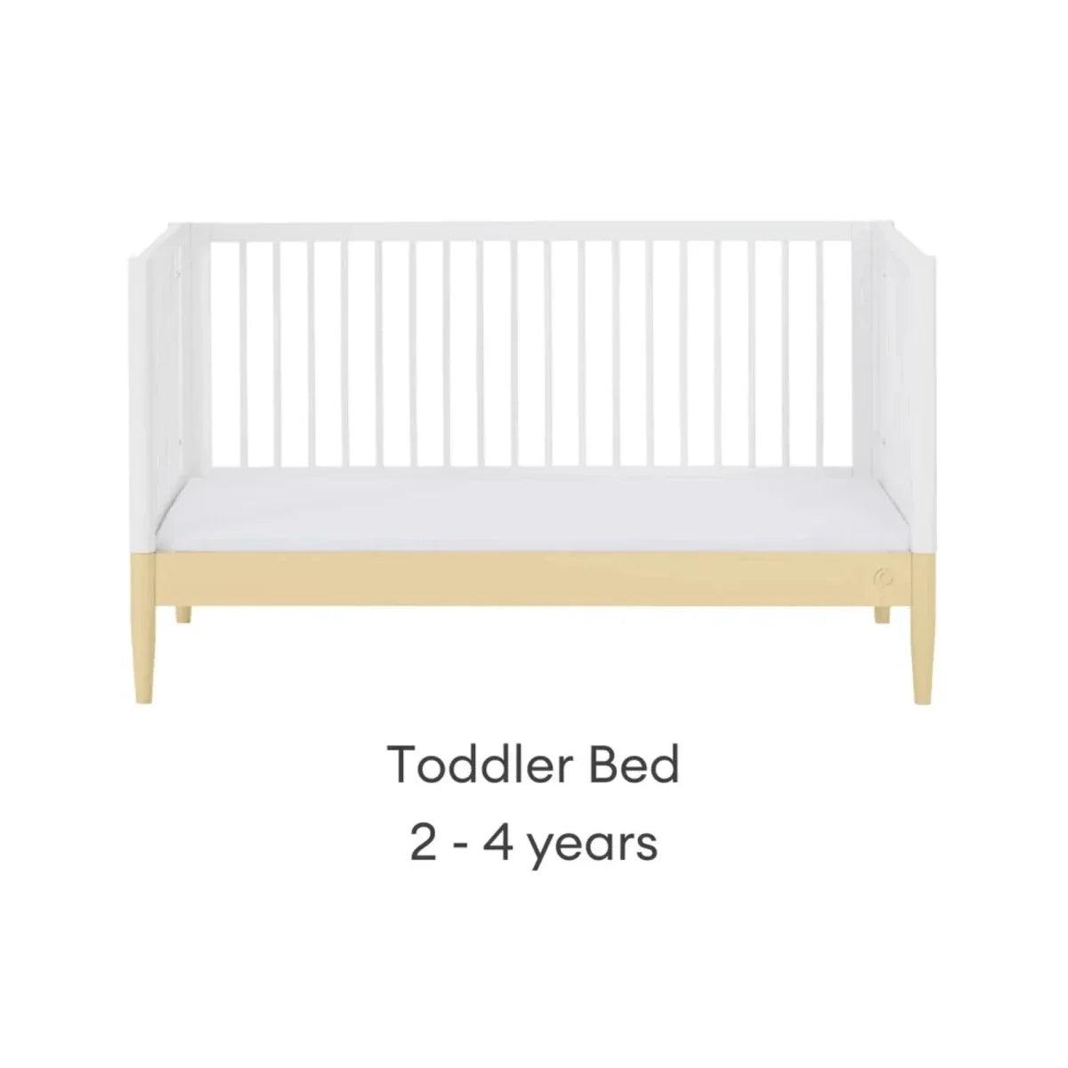 White toddler bed with primrose yellow rail, front view