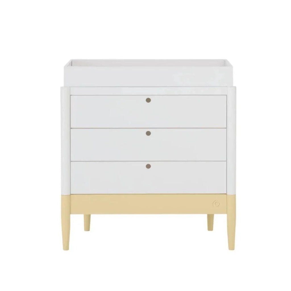 White baby dresser with three drawers and primrose yellow base trim