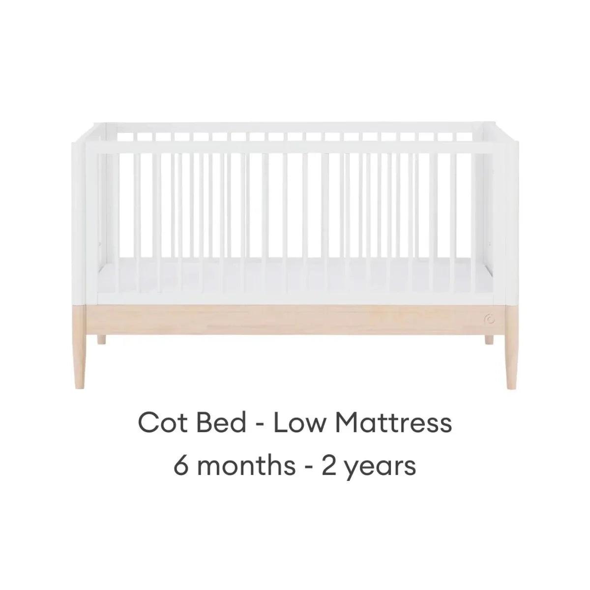 White cot bed with natural rail, low mattress position for toddlers