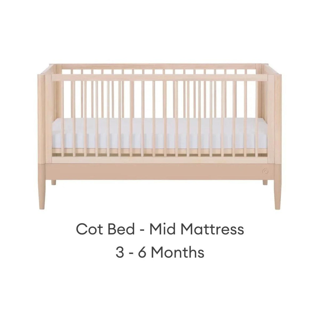 Light wood cot bed with mid mattress setting, front view