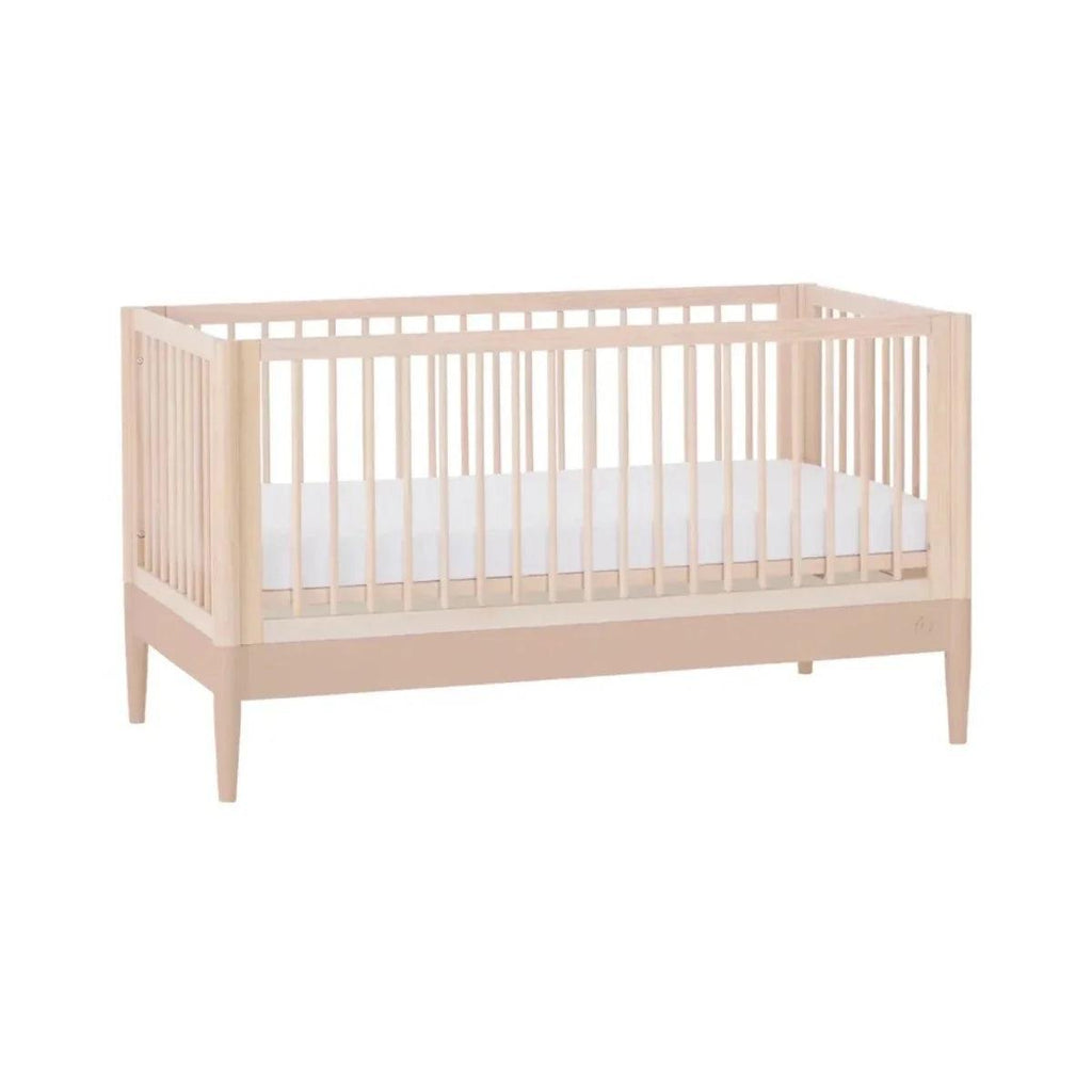 Light wood multi-stage cot bed with side rails, angled view