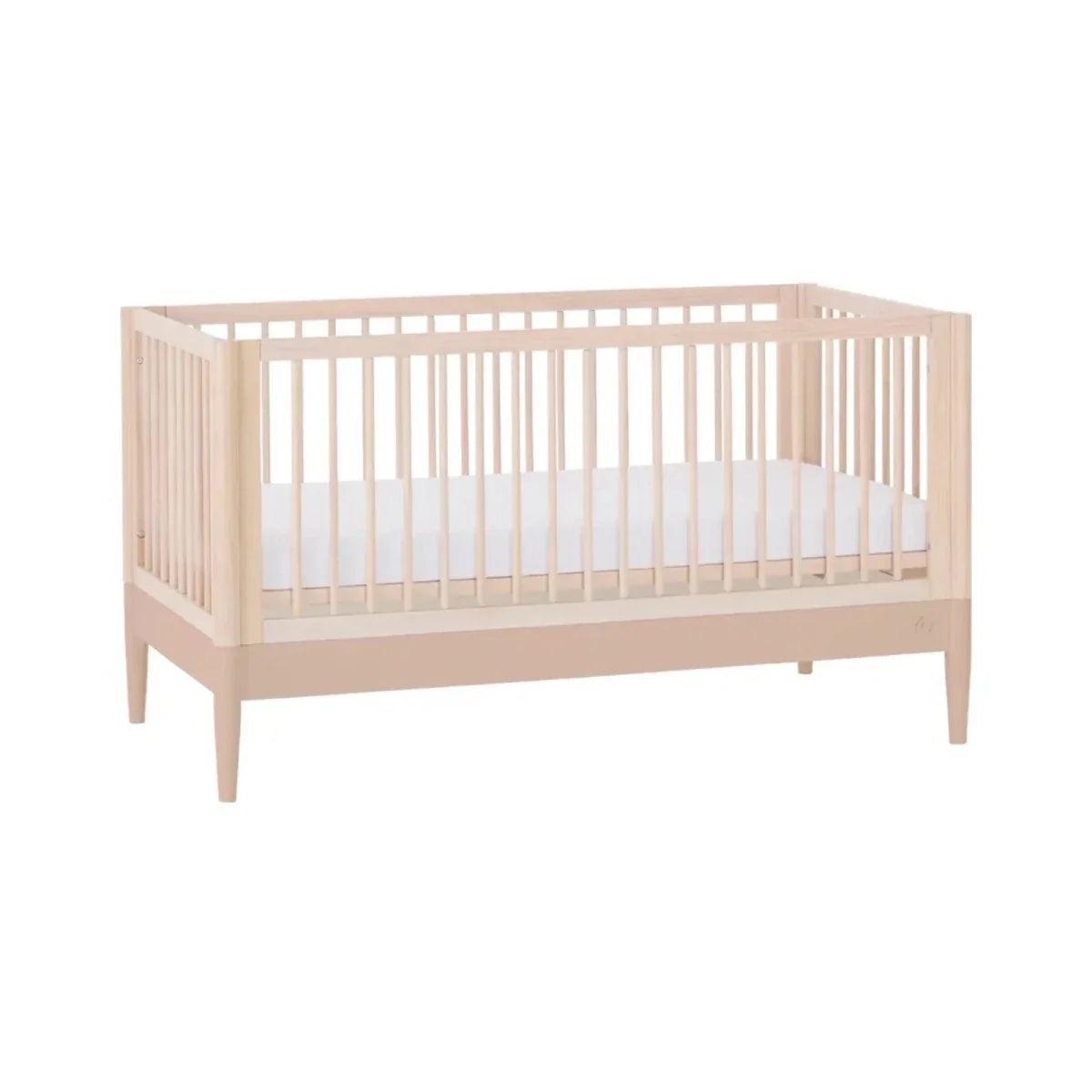 Light wood multi-stage cot bed with side rails, angled view