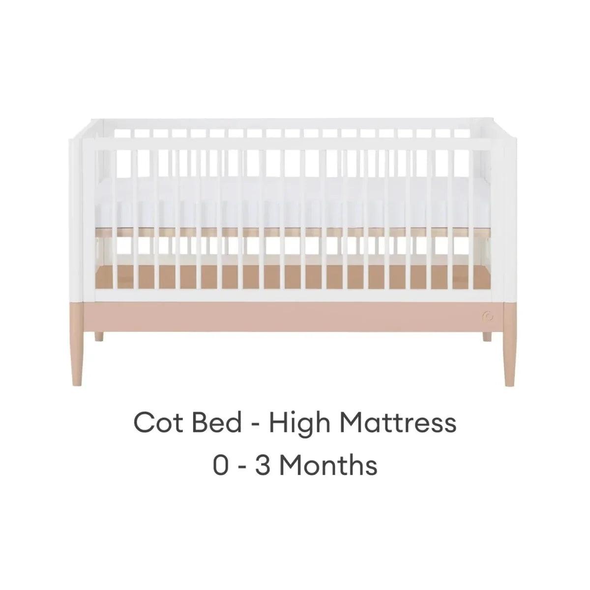 White cot bed with blush mattress band in high position