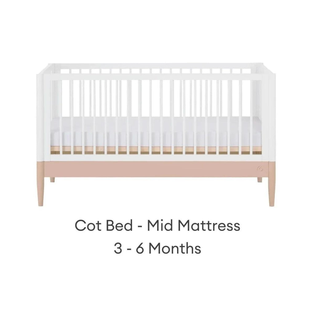 White cot bed with blush mattress band in mid position